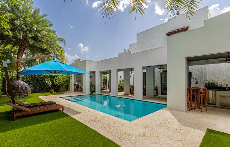 Tropical back yard with pool and artificial grass lawn